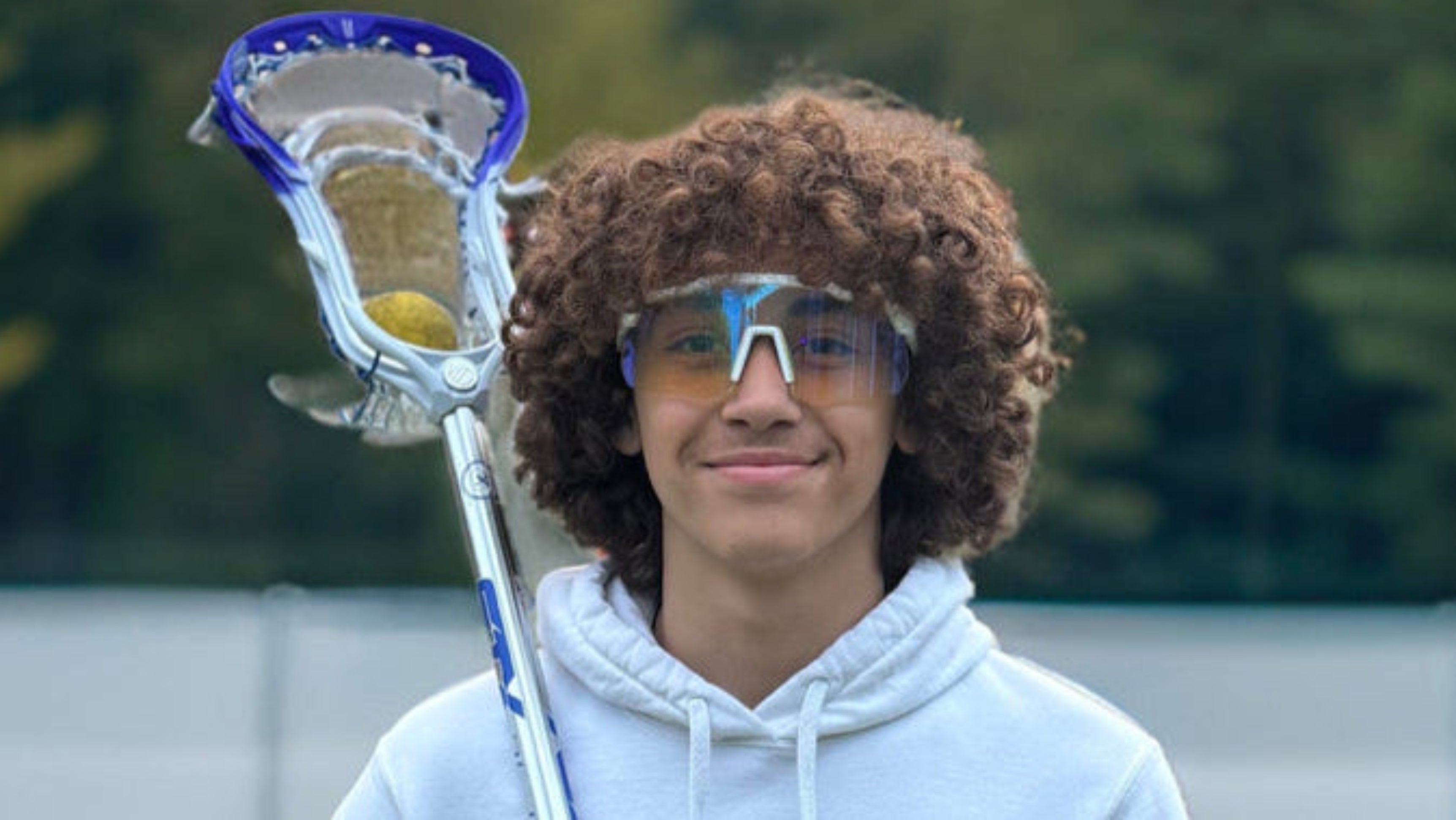 A pair of sunglasses featuring blue and white frames, stylishly designed for a modern look.