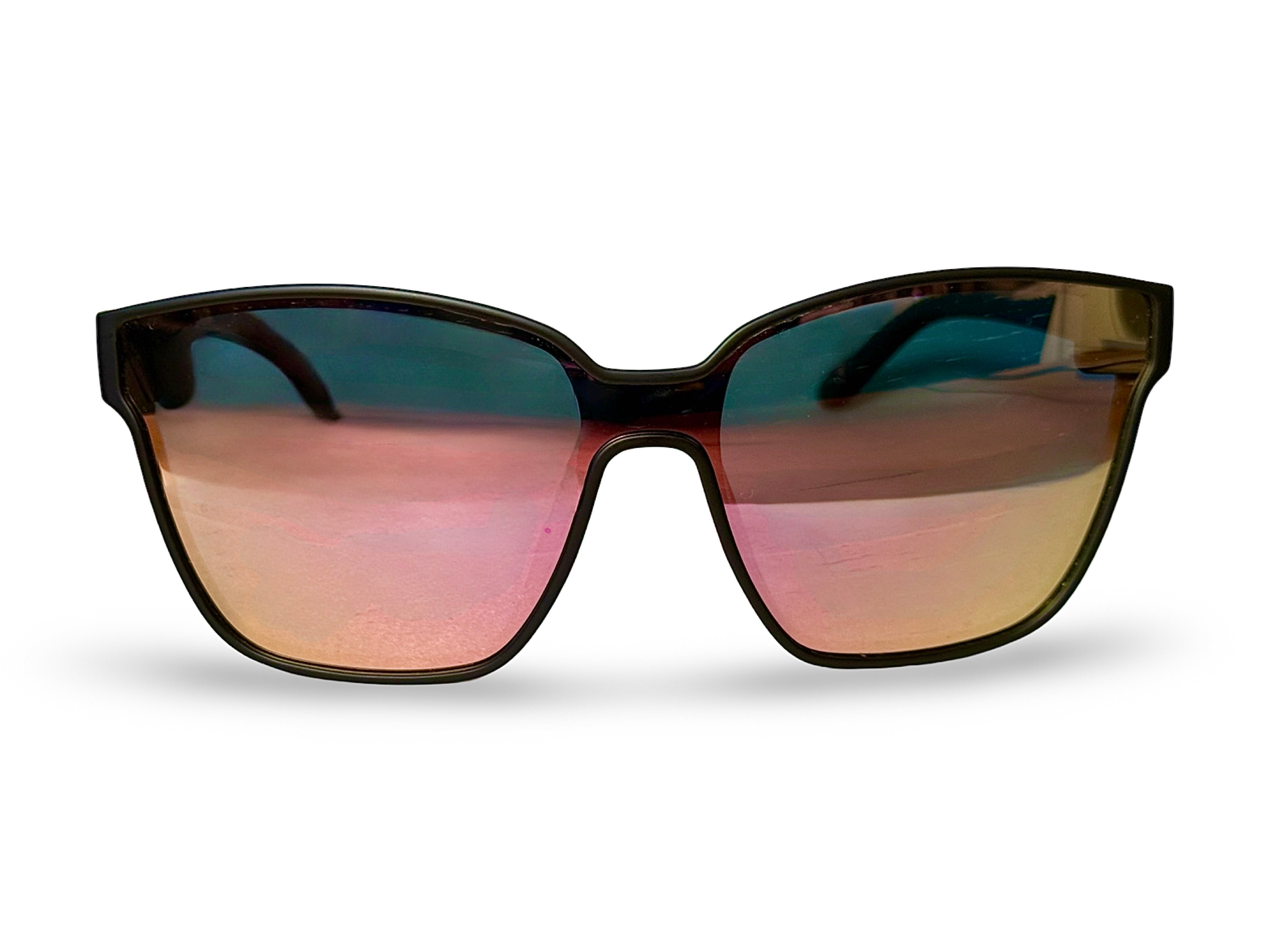 A pair of black-framed sunglasses featuring reflective silver lenses, resting on a flat surface.